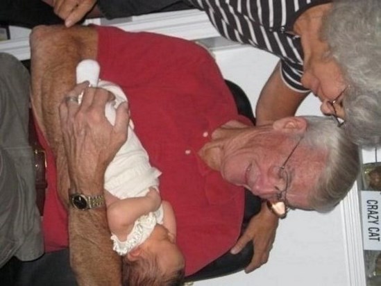 Maylin being held by Grandpa for first time 