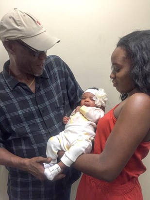 Uncle John and Zozo holding Baby Simdi in 2018 at his residence.