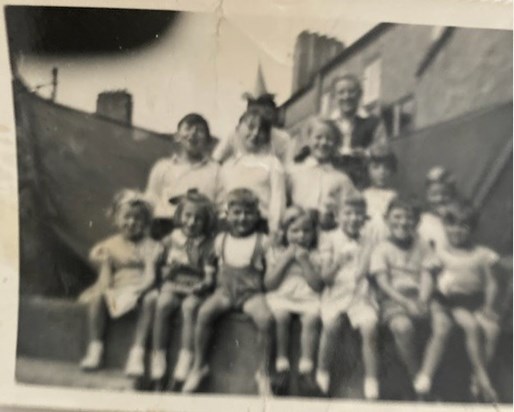 Second row on the left, from his classmate David. They thought out a Clown Show for their friends in the alleyway (Old Oak Road, East Acton), even built a stage to perform it on.