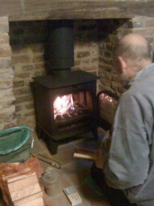 Charles enjoyed looking after the fire in his wood-burning stove. When chopping the wood he enjoyed finding interesting pieces of wood in the pile. He let the fire burn until it burned out, however late at night that was.  From 2012.