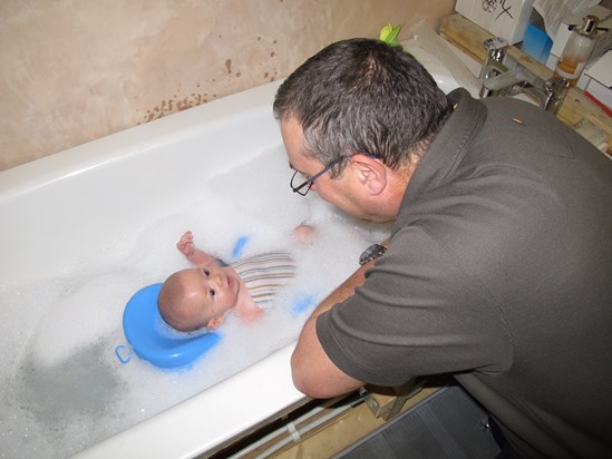 Grandpa bathing Joshua.