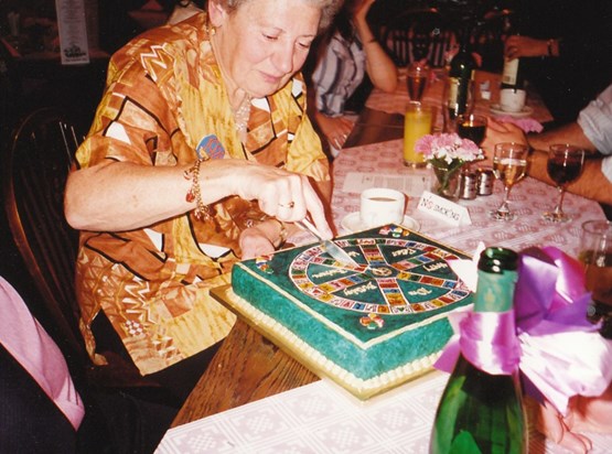Mum cutting her 70th birthday cake