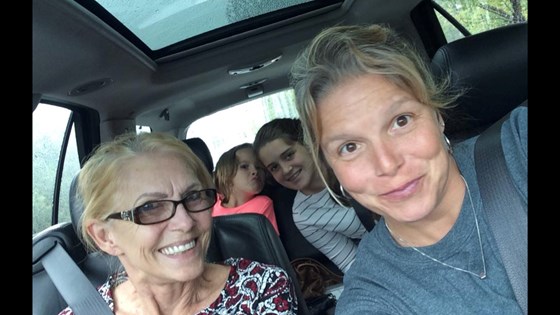 Mom Sandy with daughter Missy and Granddaughters in back seat. Everyone looks Happy. 