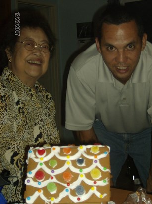 Granny and Uncle Mark posing after making a gingerbread house