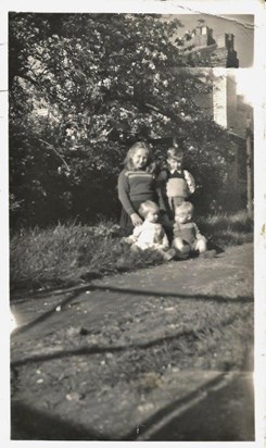 A very young Connie with her cousin Valerie and brother John and?
