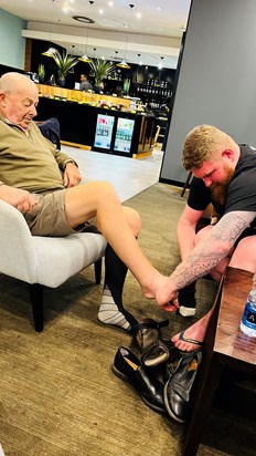 Liam helping grandad with his flight socks 🤣