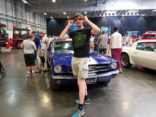 Jamie with the mustang that came before his own. 