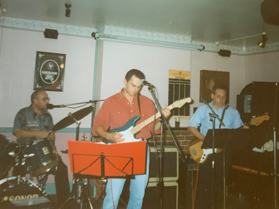 The trio at a gig with Old Harry Rocks