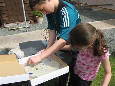 Conor and Emma put the finishing touches to the handprints
