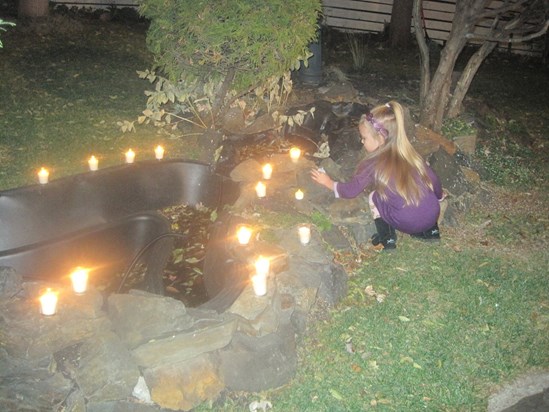 RAINE-LIGHTING CANDLE FOR HER DAD