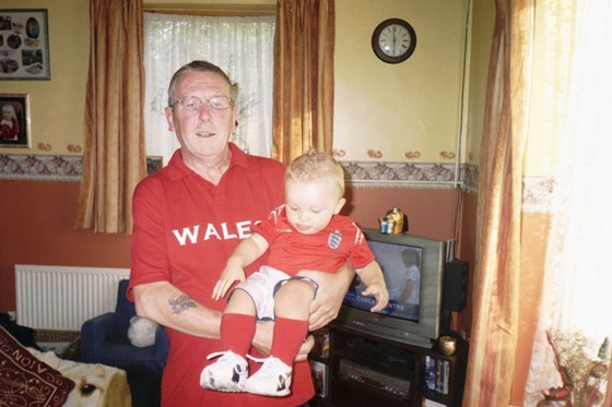 Supporting his much loved Wales rugby team with grandson Keelan.
