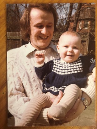 Long haired 70s Dad with baby Sam