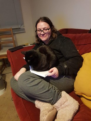 Happiest with her cat and a good book!