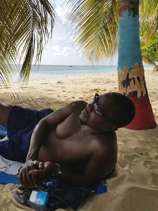 Chilling in Barbados under his favourite palm tree