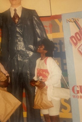 Claudette looking up at the tallest man in the world statue- New York 1989