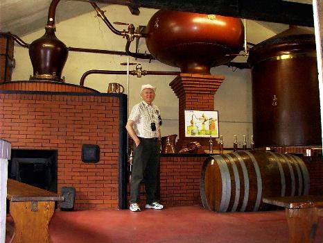 Lynn standing in front of an alambic in Cognac, France