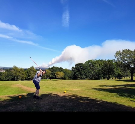 Andy enjoying his golf winter hill on fire in the background 