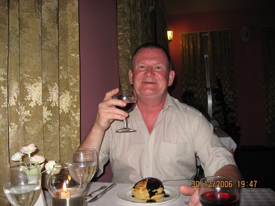 Mike enjoying a glass of red and delicious pudding