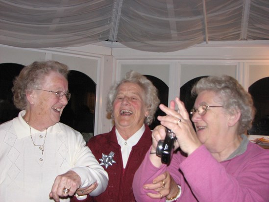 Joan laughing with her sisters at her 80th birthday celebration
