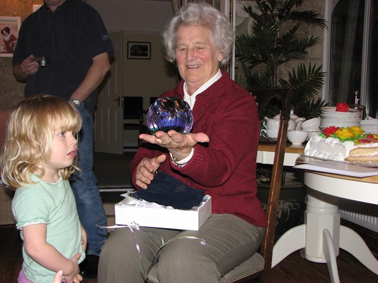 Joan and her granddaughter admiring the paperweight for her 80th birthday