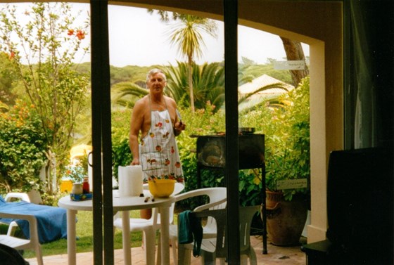 In Portugal - John borrowed my apron when the meat burned his belly