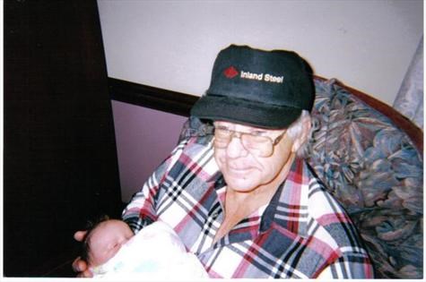 Raymond holding granddaughter, Emily in 2001