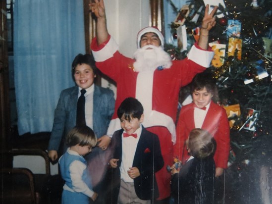 Manny playing Santa with our children 1985
