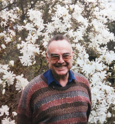 Peter in front of the star magnolia in the garden at home