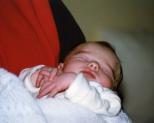 Newborn Kara in the arms of Godmother Karen