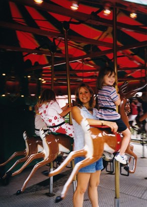 Karen and Lauren on a merry-go-round in Story Land