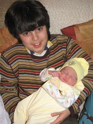 Adnan holding rayan (his cousin) when he was 6 days old!