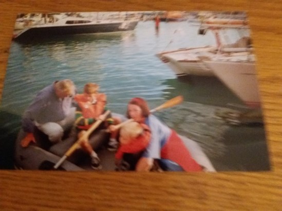 Ian teaching Alex to row the dinghy in Yarmouth Harbour with my mum and i