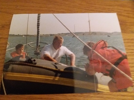 Ian blowing the dinghy up on his boat with Alex and myself 