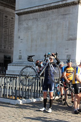 Iain celebrating completing the London to Paris cycle ride in the traditional way at l'Arc de Triomphe 