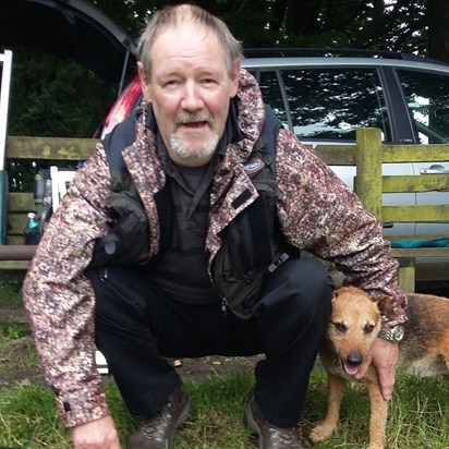 Dad with his friend's dog on 1 of his last fishing trips 