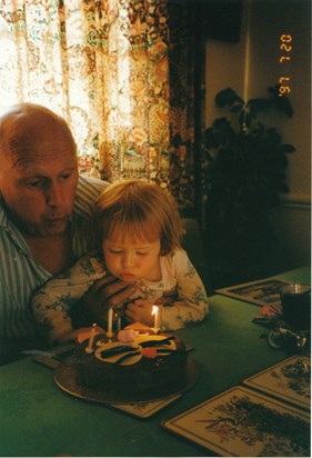 Blowing out candles on Gramps' cake