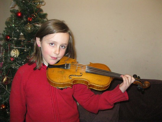 Alice demonstrating the violin for her 'Music Passion project'