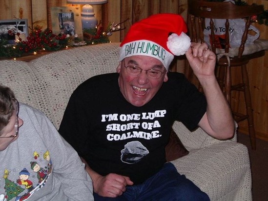 Dad giving me a hard time at Christmas with his lump of coal shirt on and his bah hum bug Santa hat