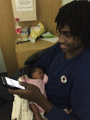 Asante with his daughter as a new born. never seen a smile so bright as on this day.