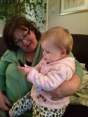 AnneMarie - with Michaela’s daughter Molly, both fascinated with phone calls.