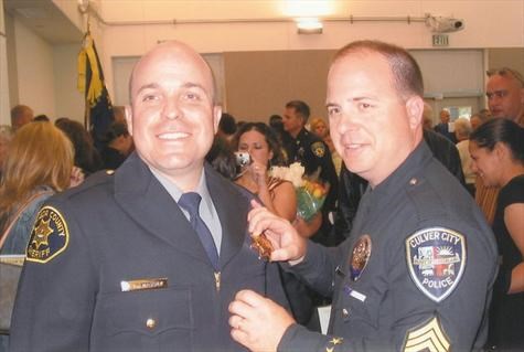 Sargeant Curt Massey proudly pins the badge on new Deputy Brett Massey   2006