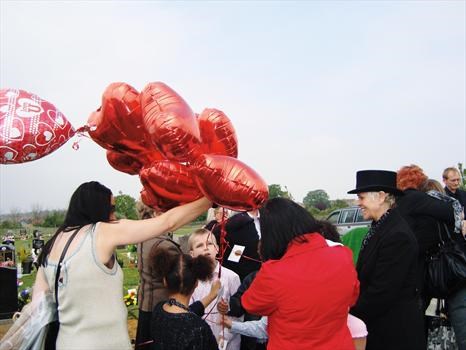 Clair and Rowena, releasing heart shaped balloons for Paul from the children    