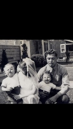 Left to right:  Wini seated with baby Brian, baby Kevin and brother Neil.