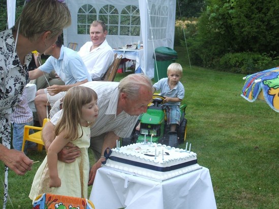 John and Jess blowing out candles on his 80th birthday