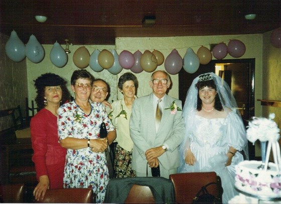 Mum on her wedding day with her mum, aunties and uncles.