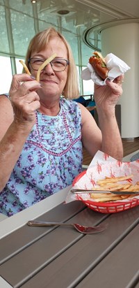 Janet tucking in giving rude signs with her chips (cruise 2019)