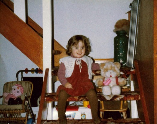 Lucy sitting on our stairs at Eastney aged nearly 3