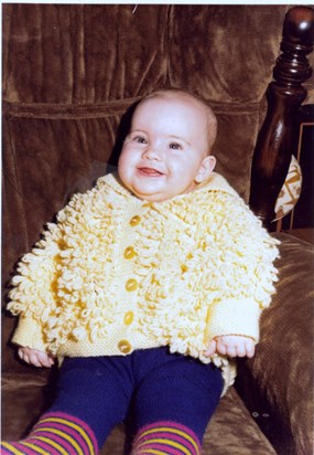 Lucy aged 7months in a cardigan knitted by NanNan