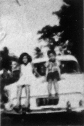 Elizabeth & Raymond, back of the Ford Consul, driveway of the old house