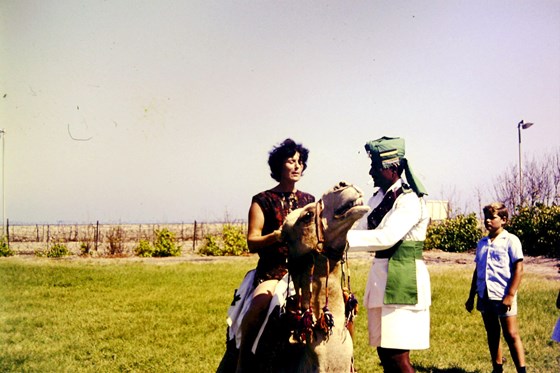 Mary giving camel riding instruction to a South Arabian soldier!